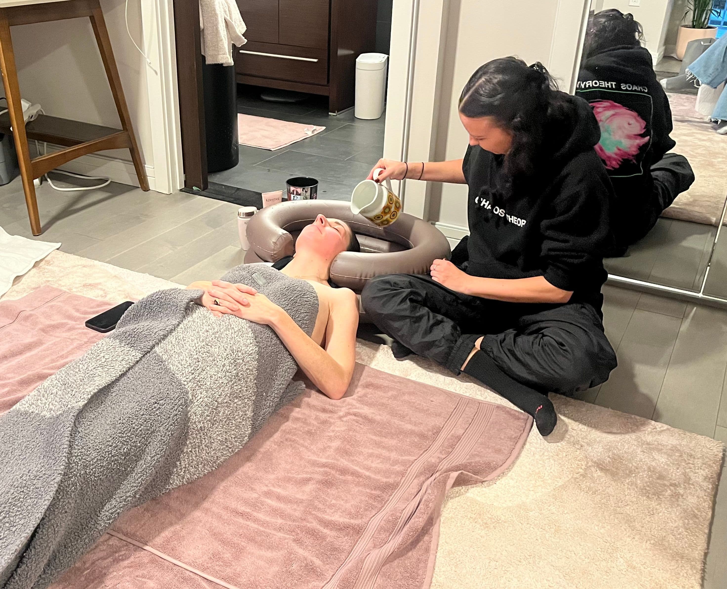Netty Jordan and Jennifer Schorr washing Jen's hair after chemo treatment.