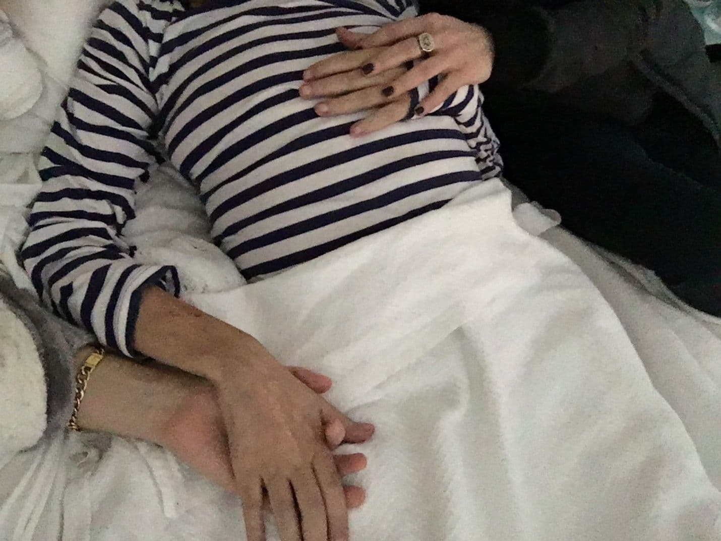 Elizabeth Gilbert and Rayya Elias, holding hands on deathbed